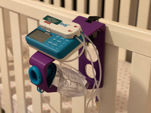 Purple Tubie Tower securely attached to Crib using built-in velcro strap. Moog 500ml bag with Infinity pump.