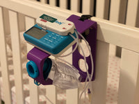 Purple Tubie Tower securely mounted to crib with included 12 inch velcro strap